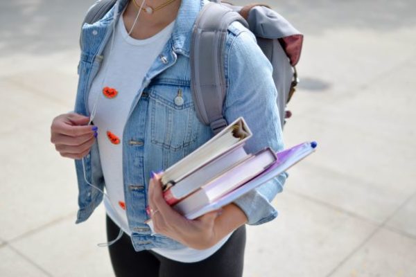 student holding books